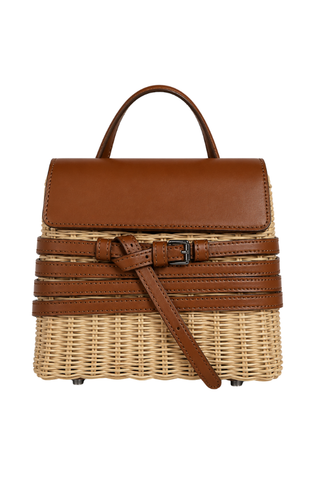 Loana Crossbody Bag in brown, front view with leather flap, woven straw body, buckled straps and top handle