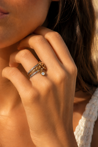 Rebecca Two Toned Ring, worn on a finger on a model