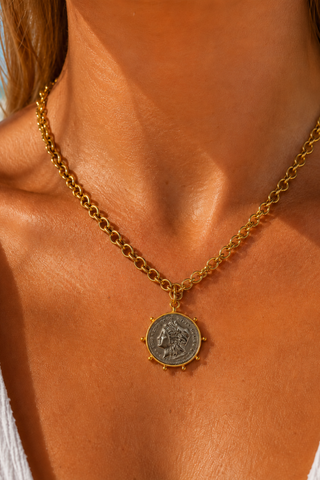 Alissa Two Toned Coin Necklace worn on the neck, gold chain with silver-tone coin pendant at the collarbone