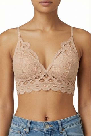 Our Lace Bralette in beige, front view with scalloped lace hem and thin straps, worn with jeans