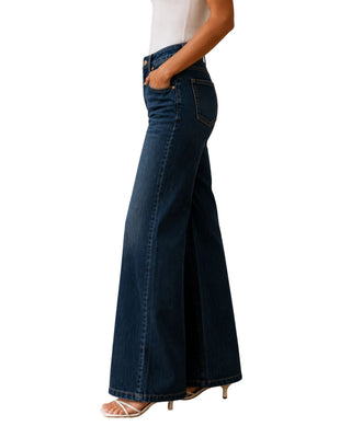 Arabella High Rise Wide Leg Adjustable Jeans in dark wash, side view with hand in pocket and strappy heels