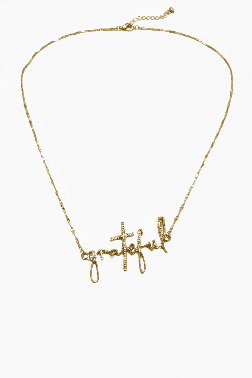 Gold necklace with script-style letters on a white background