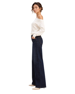 Ultra Soft One Shoulder Sweater in cream, side view showing the bare shoulder and ribbed cuff