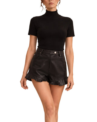 Pleather Ruffle Short in black, close-up front showing button waist and ruffle hem