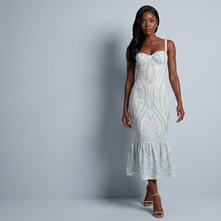 Woman in a pale green tiered midi dress