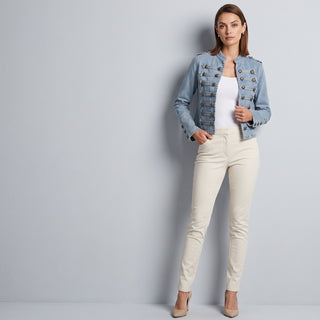 Woman in a denim jacket and cream jeans