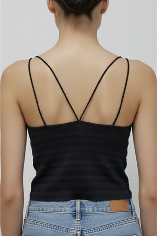 Elara Bralette Cami in black, back view showing crossing double straps and a small leather tag on the jeans